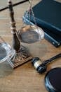 pexels photo 5668882 5668882 From above of judicial symbols consisting of Scales of Justice and small judge hammer with curly handle